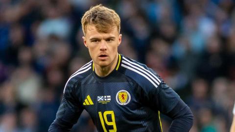 Tommy Conway running on the pitch during Scotland's game with Finland