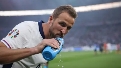 England captain Harry Kane drinks from a water bottle