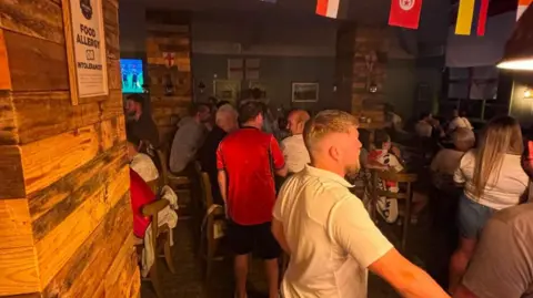 England fans gathered in The Hod Carrier, Leamington Spa, which has been decorated with World Cup flags