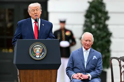 AFP via Getty Images US President Donald Trump speaks as Britain's King Charles III looks on during an arrival ceremony on the South Lawn of the White House in Washington, DC, on April 28, 2026. 