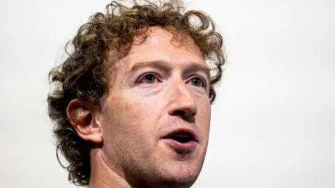 Getty Images Close-up of Mark Zuckerberg with white background behind him at a promotional event