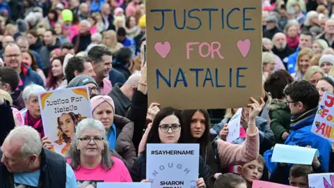 Pacemaker Press A wide shot of some of the hundreds of people who attended a public rally following the murder of Natalie McNally in Lurgan. Several young women at the front of the crowd are holding placards. Two of them read: "Justice for Natalie."
