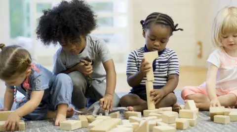 A group of children playing together with some toys.