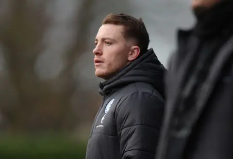 Getty Images Dan Lawlor watches a match from the touchline