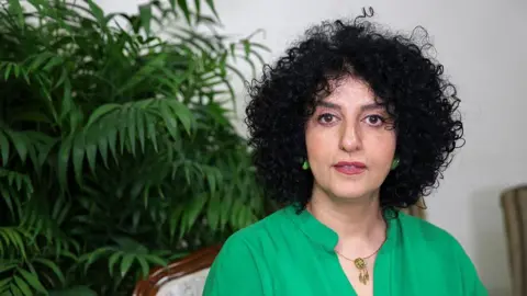 Middle East Images/AFP via Getty Images Narges Mohammadi sits in her apartment in Tehran on 16 January 2025