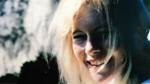 Handout Carole Packman squints as she smiles broadly on a sunny day.