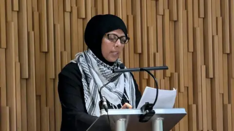 Labour councillor Irim Ali, Newcastle City Council's cabinet member for communities, speaking at a meeting on Wednesday. She is standing at a podium and speaking into a microphone.
