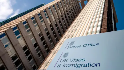 British immigration concept with Lunar House building the Home Office Visas and Immigration Office in Greater London, England, UK