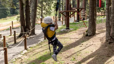 child using a zip wire