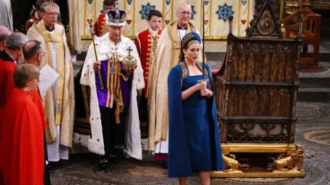 PA Media Penny Mordaunt carrying sword