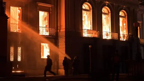 AFP Firefighters work as a massive fire engulfs the National Museum in Rio de Janeiro on 2 September 2018