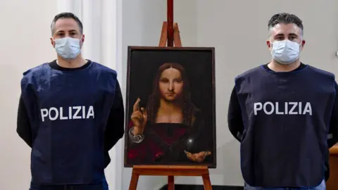 EPA Image shows two police officers stood next to the recovered painting