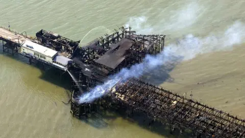 PA Aerial photo showing smouldering buildings on Southend Pier