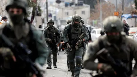 Reuters Israeli security personnel work at a scene where a suspected incident of shooting attack took place