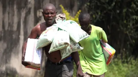 Getty Images A man carrying bags of rice