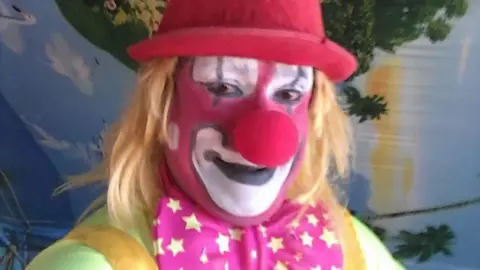 Rambo Circus Clown poses for a selfie