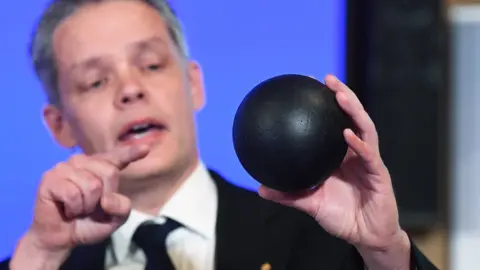 EPA Ulf Danielsson demonstrates the concept of a black hole using a ball