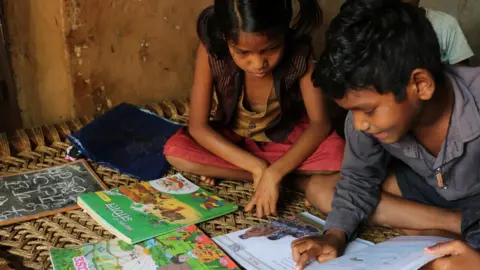 Vishnu reads aloud to Radhika.