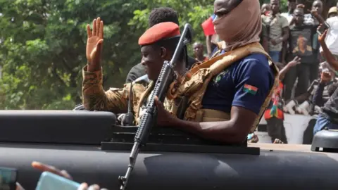 Reuters Burkina Faso's couple leader Ibrahim Traoré waves as he arrives in an armoured vehicle in Ouagadougou, Burkina Faso - 2 October 2022