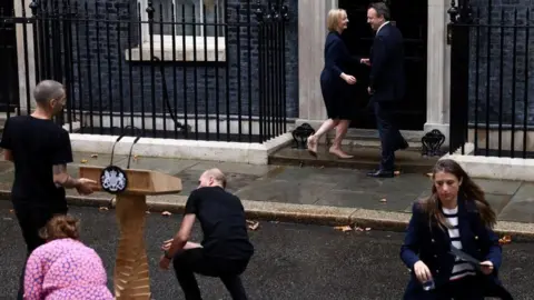 Reuters Liz Truss and Hugh O'Leary head towards the Downing Street door