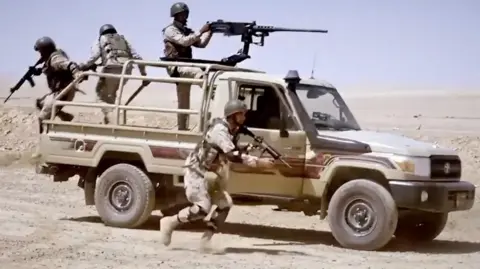 Jordanian soldiers jump from a vehicle