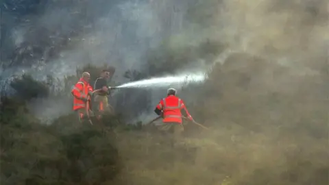 Getty Images Firefighters tackle moorland fire