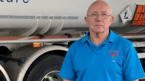 Colin Owens in front of truck