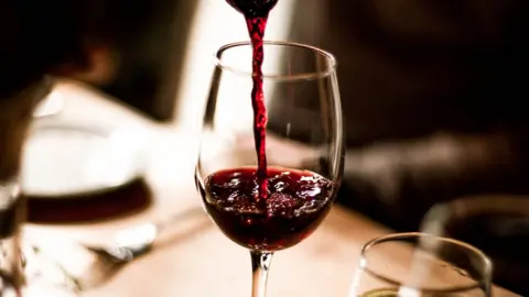 Getty Images Red wine poured into a glass