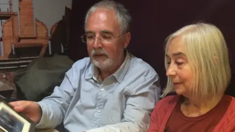 Brian Felton and Lesley Willett look at Frank Willett's wedding photo