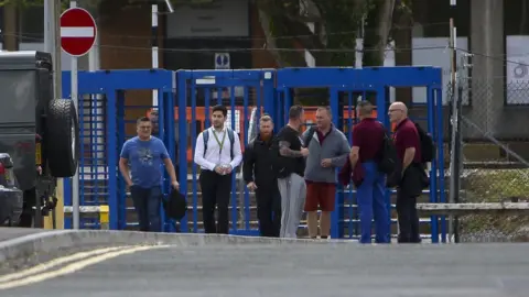Getty Images Workers leaving the plant when the closure was announced in June 2019