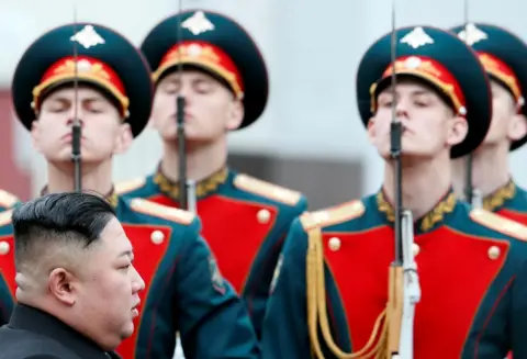 Shamil Zhumatov/Reuters North Korean leader Kim Jong Un walk past a guard of honour as he arrives at the railway station in the Russian far-eastern city of Vladivostok