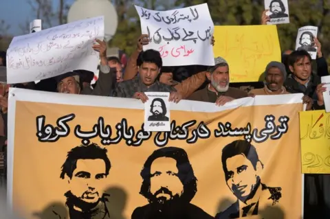 Getty Images Pakistani human rights activists hold images of bloggers who have gone missing during a protest in Islamabad on January 10, 2017.