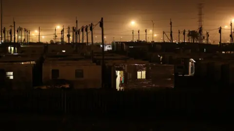 Reuters Power lines pictured at night in Khayelitsha township, South Africa - Tuesday 10 July 2018