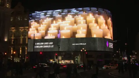 Pool Candles are projected on a screen in Piccadilly Circus