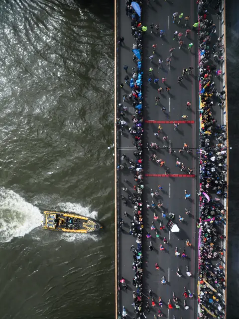 Alishia Abodunde/Getty Images Runners cross Tower Bridge during the 2024 TCS London Marathon at on April 21, 2024 in London, England.