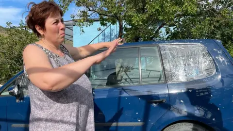 BBC Natasha shows damage to cars driven from Mariupol to Georgia