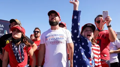 Reuters A girl raises a hand as she reacts during U.S. President Donald Trump"s campaign rally at Laughlin/Bullhead International Airport in Bullhead City, Arizona, U.S., October 28, 2020