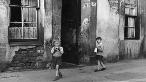 B Marshall/Getty Images Children in the Gorbals