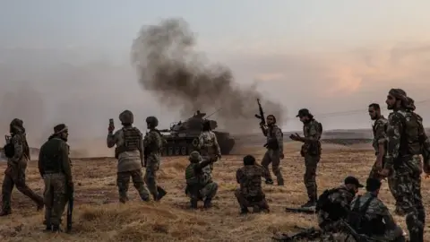 AFP Turkish soldiers and allied Syrian fighters on the outskirts of the Syrian town of Manbij (14 October 2019)