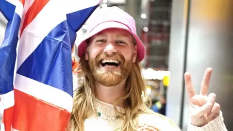 PA Media Sam Ryder arrives at Heathrow Airport in London after finishing second in the final of the Eurovision Song Contest in Italy