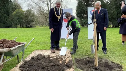 BBC Alexander helped plant one of the cherry trees watched by Cardiff Lord Mayor Rod McKerlich and Keisaku Sandy Sano