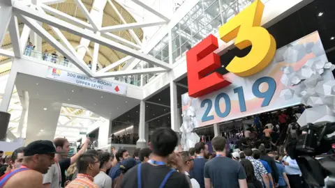 Getty Images The E3 logo sits above a door as hundreds of attendees flow through the entrance into the conference centre