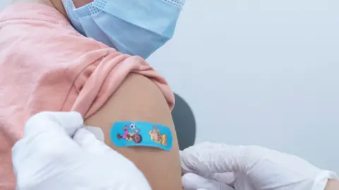 Reuters eight-year-old being injected in Switzerland