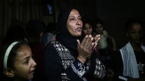 EPA Palestinian relatives mourn during the funeral of eight-month-old Layila al-Ghandour,