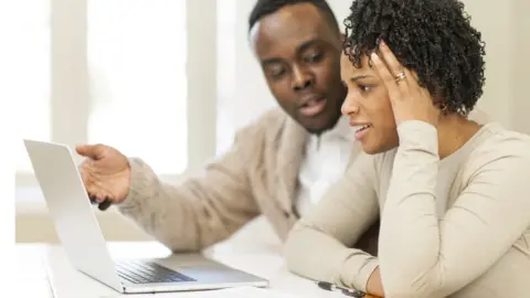 Getty Images Couple looking at laptop screen