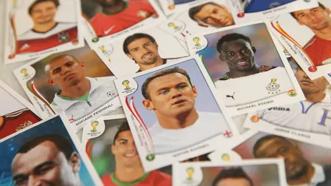 Getty Images A number of Panini World Cup 2014 stickers including England's Wayne Rooney - pictured in a plain white shirt due to licensing issues