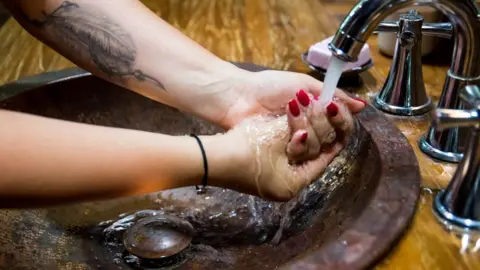 Getty Images Woman washing hands