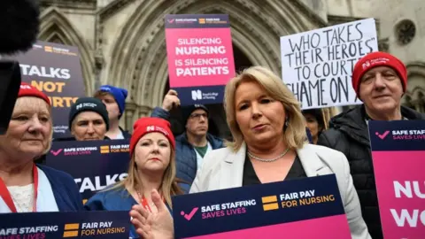 EPA General Secretary of the Royal College of Nurses Pat Cullen with nurses outside the High Court in London