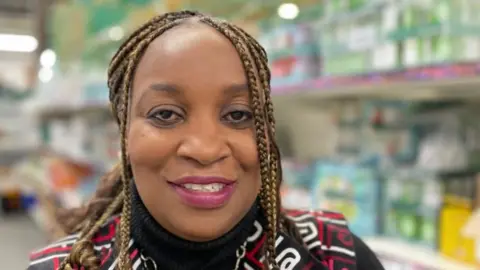 Sam Read/BBC Fola Komolafe, director of Milton Keynes food bank