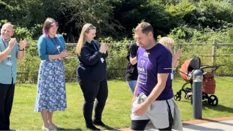 Rob Butler/BBC Grant Holt completing a charity walk